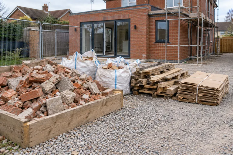 Sorted rubble, timber offcuts and cardboard awaiting collection at a building site